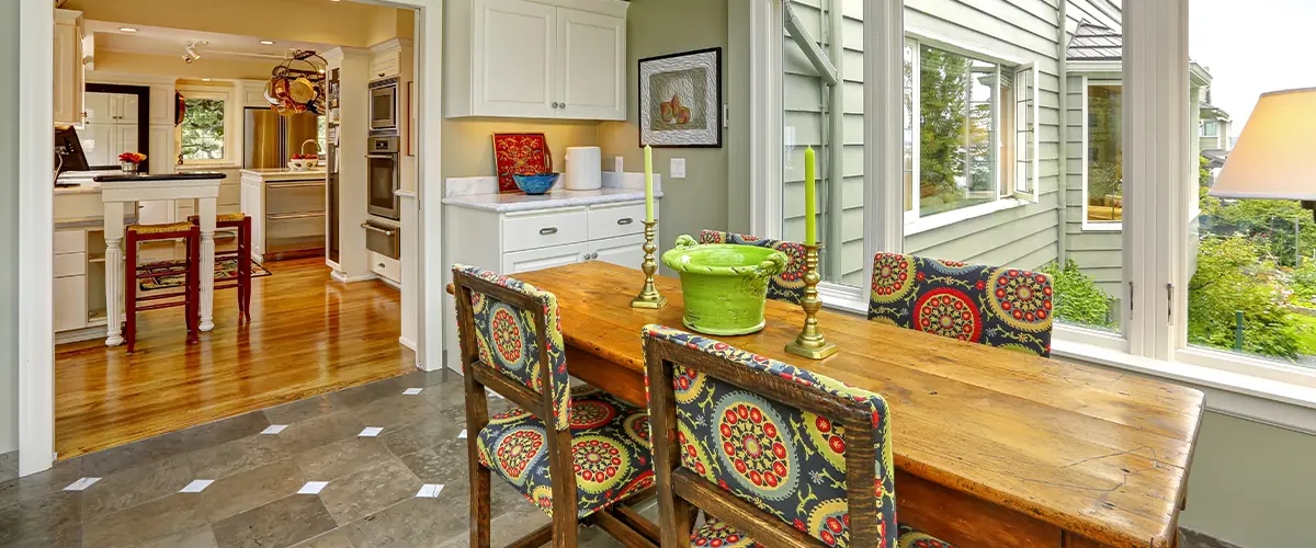 Dining room remodel with rustic wood table, patterned chairs, and natural light
