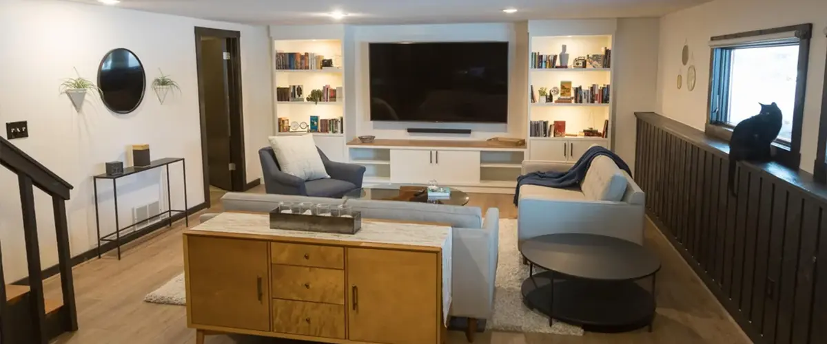 Finished basement remodel with modern living room and built-in shelves