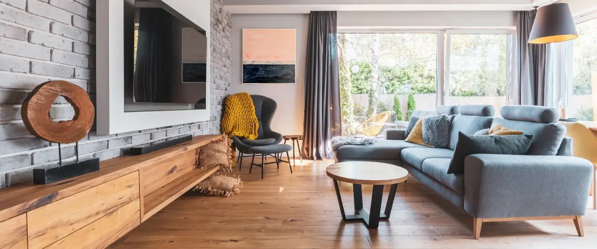 A cozy living room featuring a couch, coffee table, and a television.