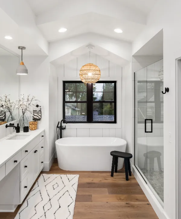 a bright, modern farmhouse-style master bathroom featuring a freestanding tub and a walk-in shower
