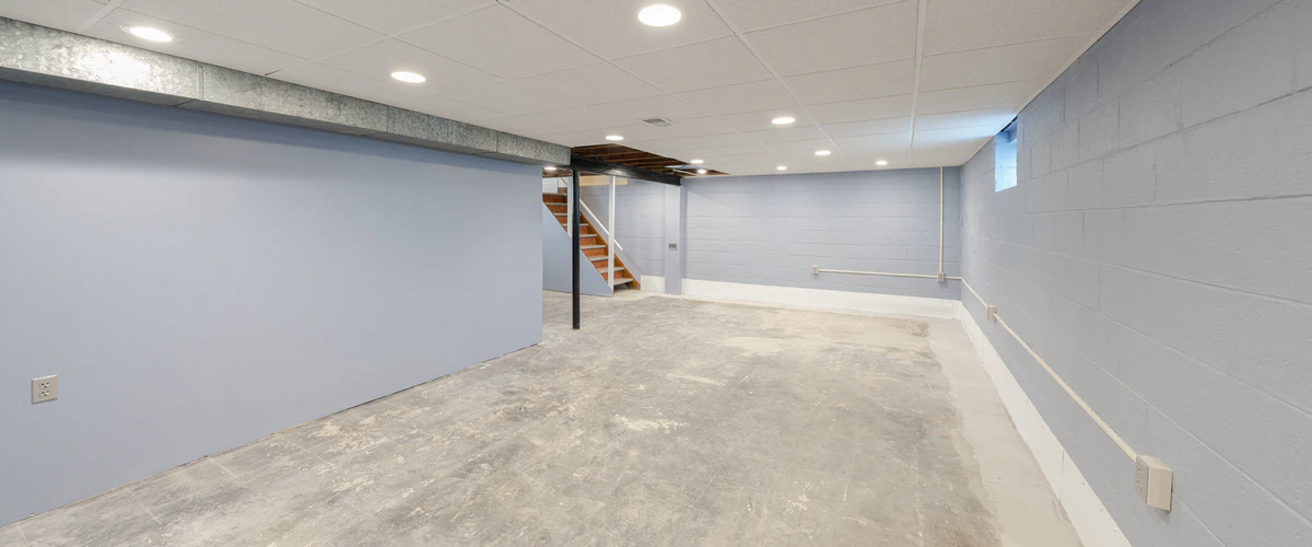 A technician applying specialized sealant to a foundation crack to ensure basement waterproofing integrity.