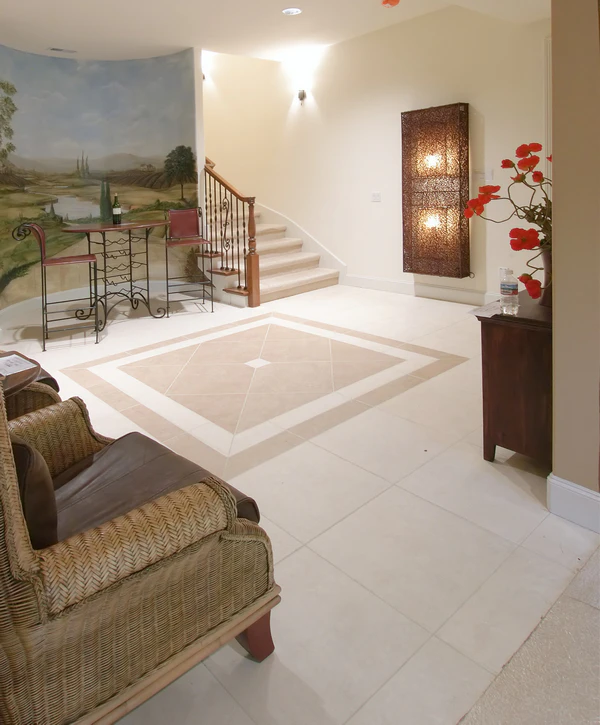 A wide view of a dry, finished basement highlighting a comprehensive waterproofing and moisture control system.