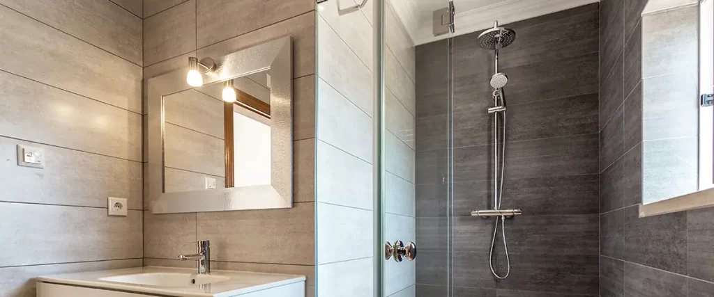 Contemporary bathroom remodel with glass shower, floating vanity, and gray tile walls