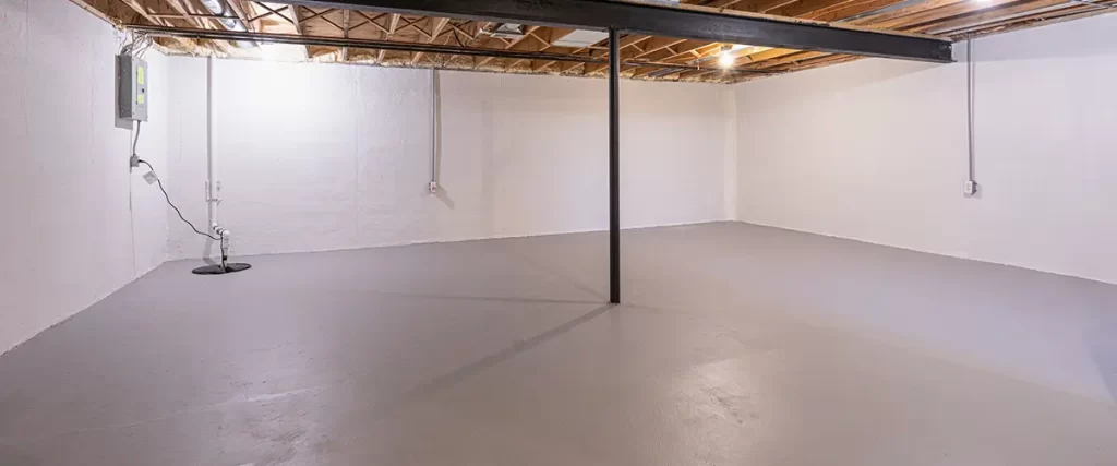Unfinished basement with sealed concrete floor and waterproofed foundation walls